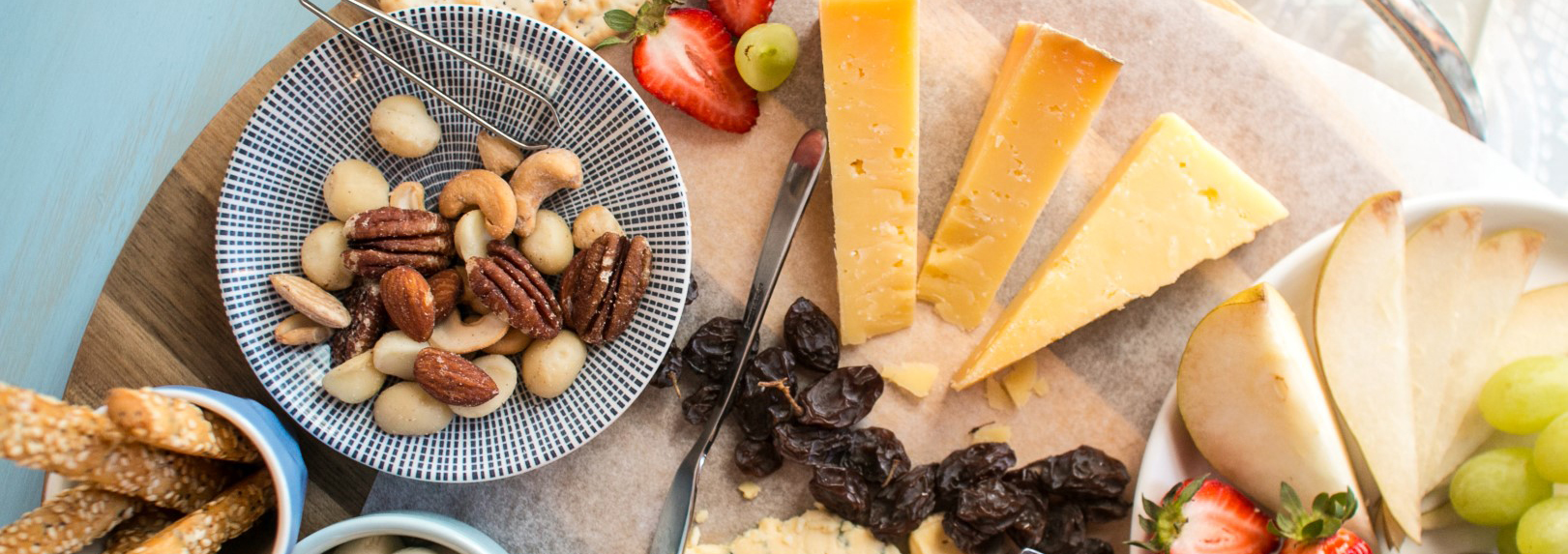 assorted cheese and nuts on board